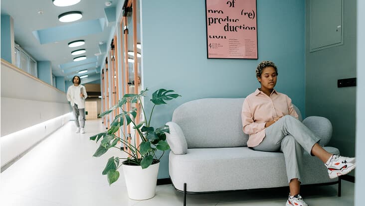 Waiting room with a person sitting on a sofa